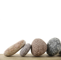 Four stones on a wood board