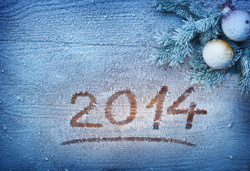 New Year 2014 on snow-covered wooden desk.