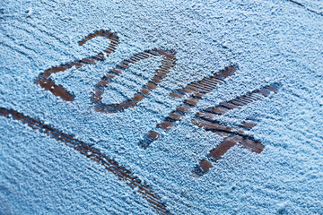 New Year 2014 on snow-covered wooden desk.