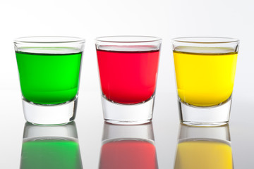 a few glasses of alcoholic drinks in red green yellow