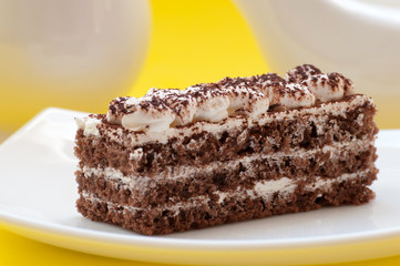 Chocolate cake on a yellow background
