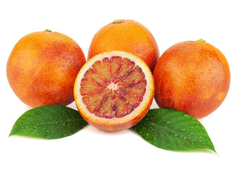 Ripe red blood oranges with cut and green leaves isolated on whi