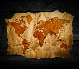 Antique world map in black wooden background