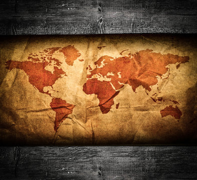 Antique world map in grunge wooden frame