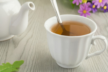 A cup of  tea and a teapot