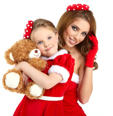 Woman and little girl wearing santa claus costume