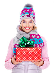 happy smiling woman giving a christmas gift