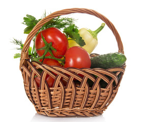 Tomatoes, cucumbers, pepper and greens in basket