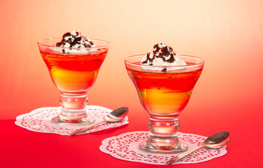 Two glasses of jelly with the whipped cream