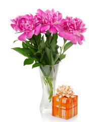 Three big pink peonies in glass vase and gift box
