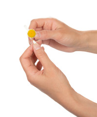 Hands which are tearing off petals at camomile