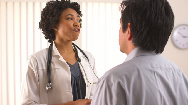 Female doctor talking to Hispanic patient