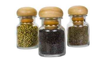 Three containers of assorted spices
