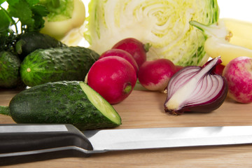 Set of vegetables and knife on a chopping board