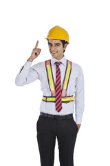 Male architect pointing and smiling