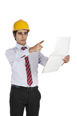Male architect holding a blueprint and pointing