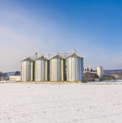 landscape with silo and snow white acre with blue sky © travelview