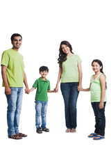 Obraz premium Portrait of a happy family holding hands