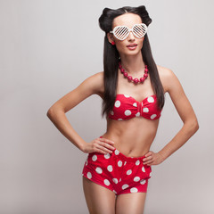 Pin Up model in heart shaped sunglasse