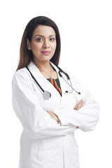 Fototapeta premium Female doctor standing with her arms crossed