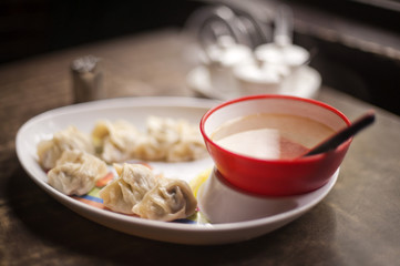 Close-up of dumplings with a bowl of soup