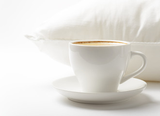 Cup of coffee and white pillow