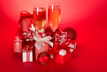 Two wine glasses with champagne and gift boxes