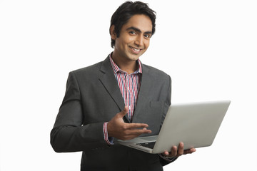 Businessman using a laptop and smiling