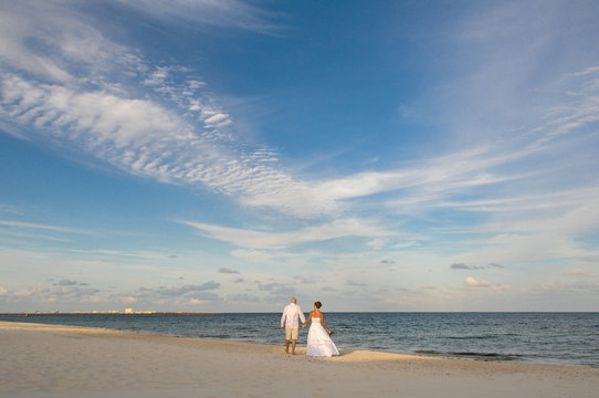 Wedding couple walking on the beach