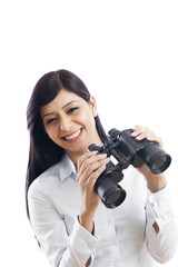 Portrait of a businesswoman holding binoculars and smiling
