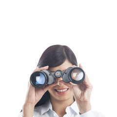 Businesswoman looking through binoculars