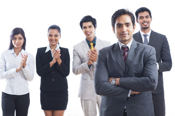 Portrait of business executives smiling and applauding