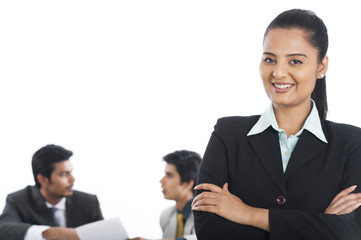 Portrait of a businesswoman smiling with her colleagues in the background