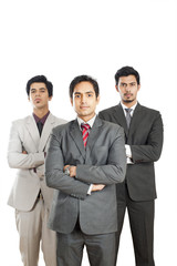 Portrait of three businessmen standing with their arms crossed