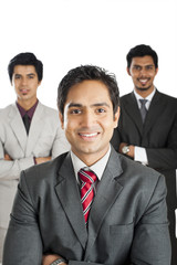 Portrait of a businessman smiling with his colleagues in the background