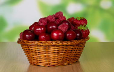 Basket with cherry and strawberry berries