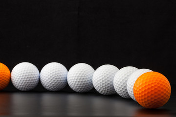 Golf balls on the black background