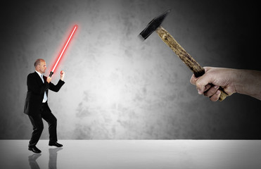 Businessman fighting  with a laser-sword - business challenge
