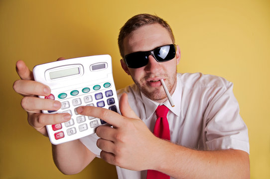 Young business man showing calculator
