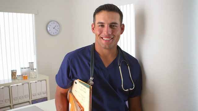 Hispanic doctor smiling in medical office