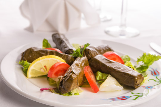 Turkish Style Dolmas Arranged with Tomatoes Lemon and Lettuce