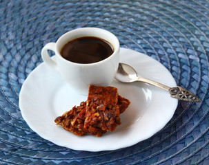 Homemade candy apple with nuts and a cup of coffee