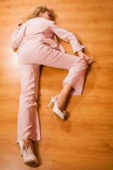 Unconscious business woman lying on the floor