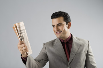 Businessman holding a newspaper