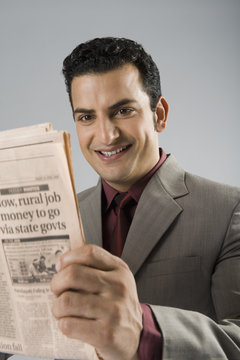 Businessman holding a newspaper
