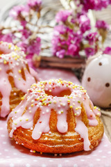 Traditional easter yeast cake covered with pink icing and color