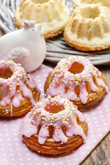 Obraz na płótnie Canvas Traditional easter yeast cake covered with pink icing and colorf