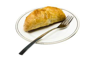 Close-up of a stuffed pastry with a fork in a plate