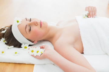 Obraz na płótnie Canvas Beautiful woman lying on massage table in beauty salon
