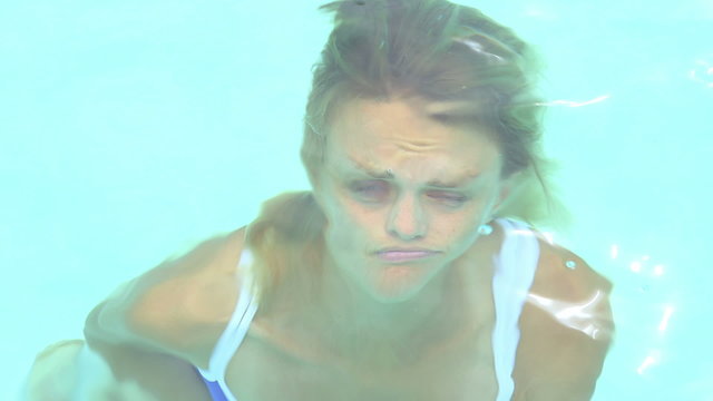 woman standing at the bottom of pool